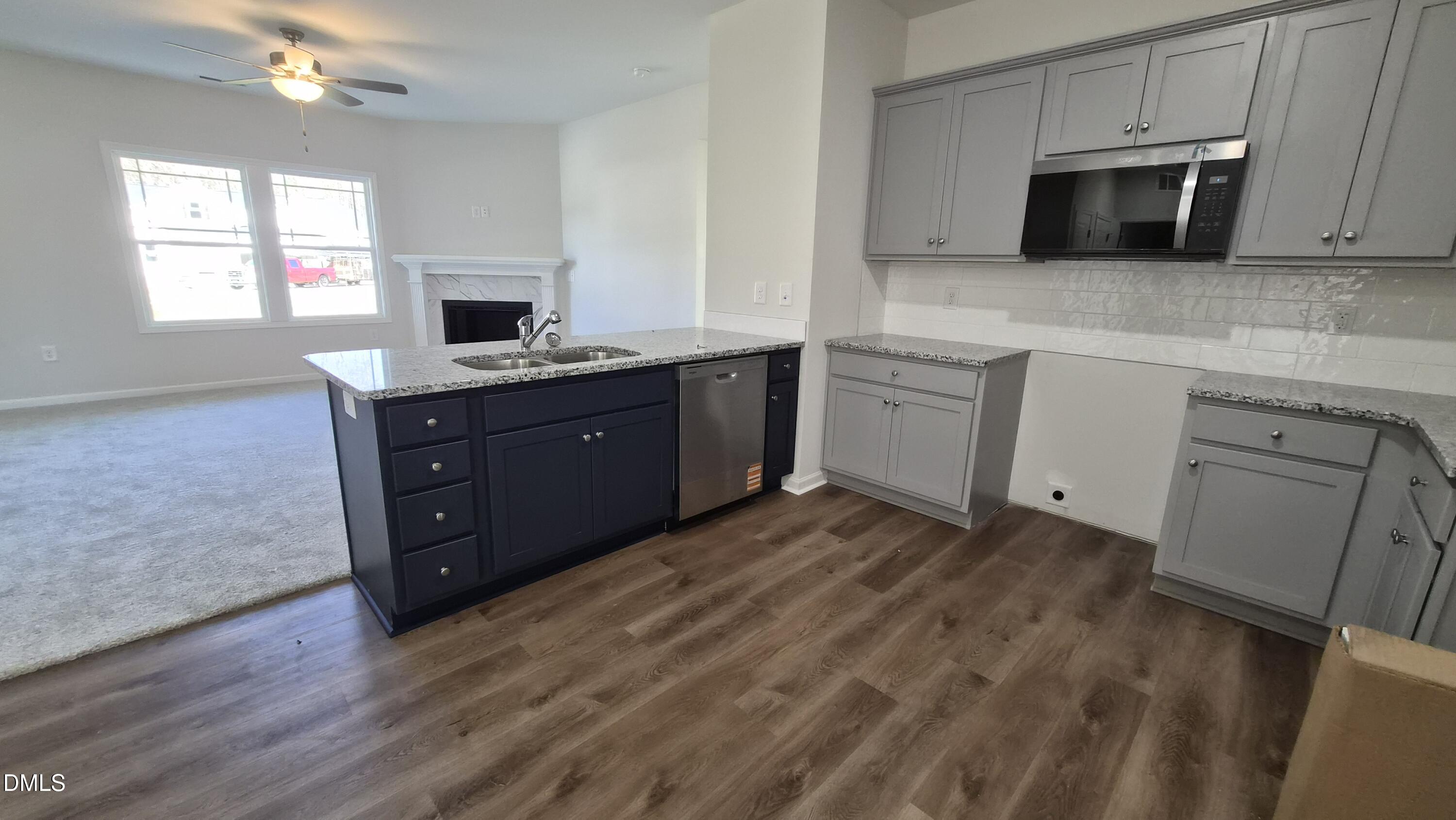 313 Bonsai Way Four Oaks, NC 27524 - Photo 6 of 21 a kitchen with granite countertop a sink and a stove top oven