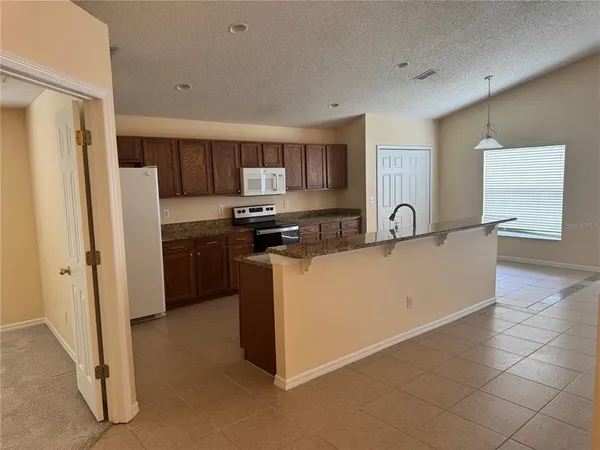 a kitchen with stainless steel appliances a refrigerator sink and stove