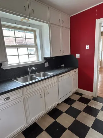 a kitchen with a sink a stove and a window