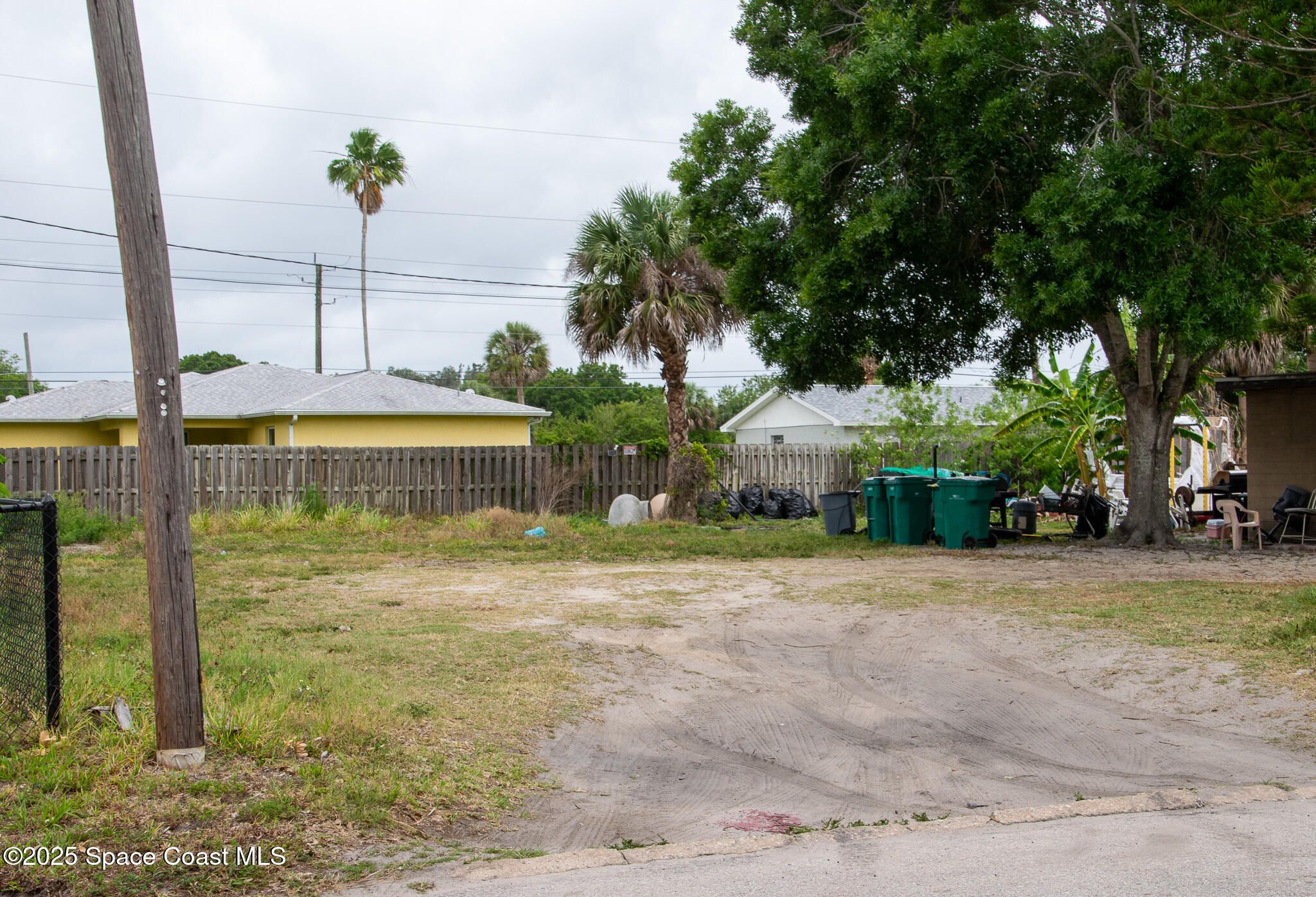 2902 Colbert Circle Melbourne, FL 32901 - Photo 1 of 2 a backyard of a house with table and chairs under an umbrella