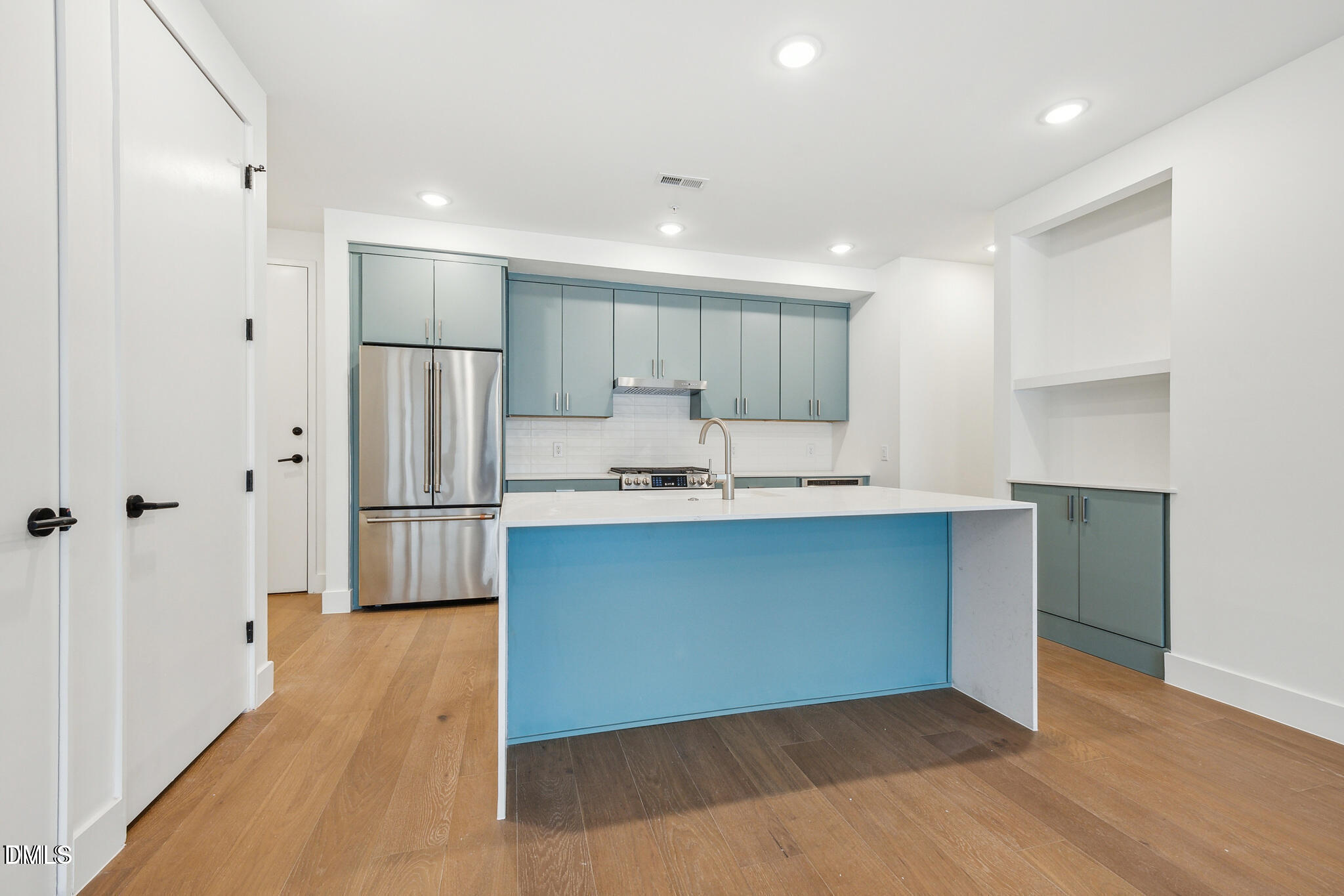 29 Enterprise Street, Unit 109 Raleigh, NC 27607 - Photo 5 of 18 a kitchen with stainless steel appliances a refrigerator sink and cabinets
