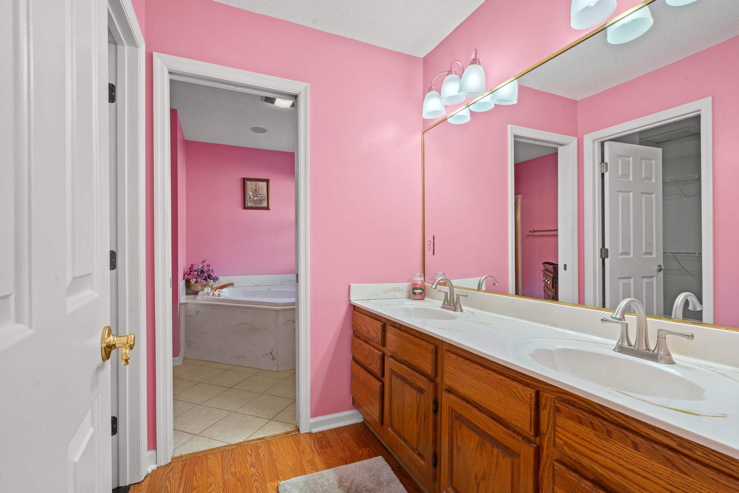 3106 Robyn Court Little River, SC 29566 - Photo 18 of 37 Full bathroom featuring double vanity, a bath, and light wood-type flooring
