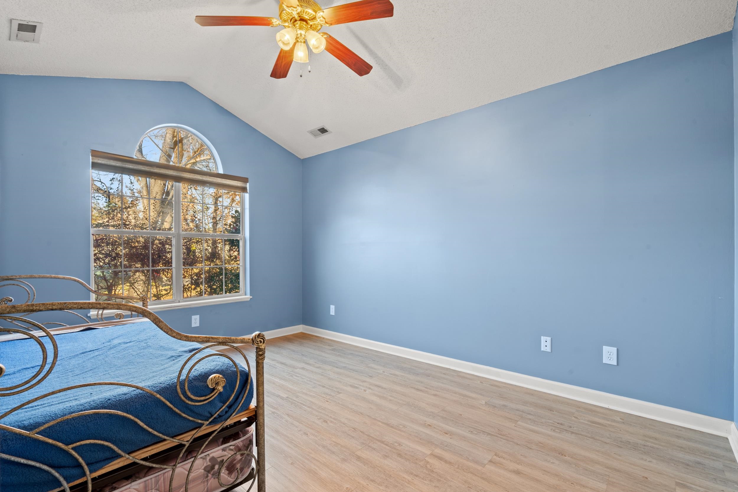 3106 Robyn Court Little River, SC 29566 - Photo 20 of 37 Bedroom featuring vaulted ceiling, ceiling fan, light wood-type flooring, and a textured ceiling