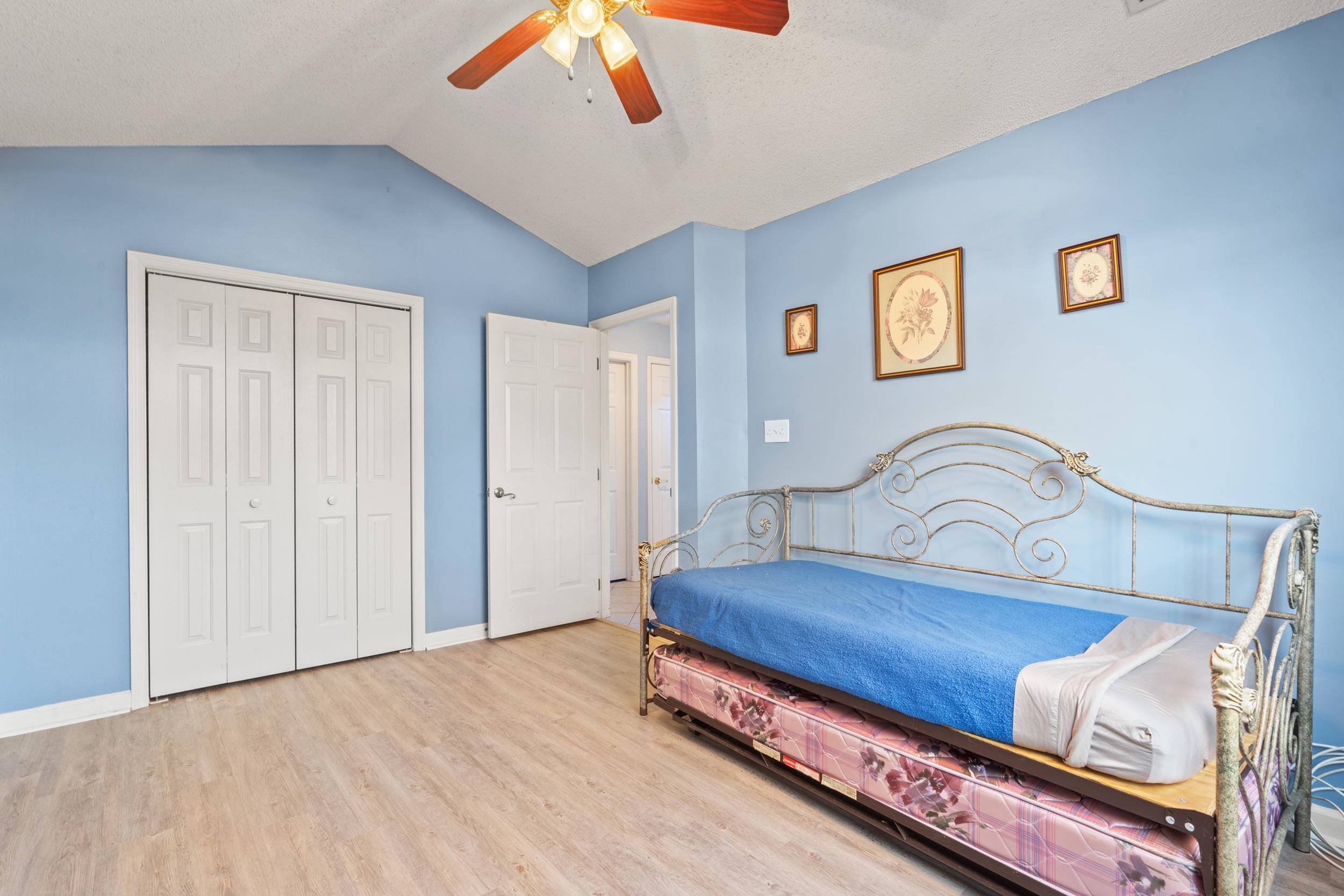 3106 Robyn Court Little River, SC 29566 - Photo 22 of 37 Bedroom with vaulted ceiling, a closet, wood finished floors, and ceiling fan