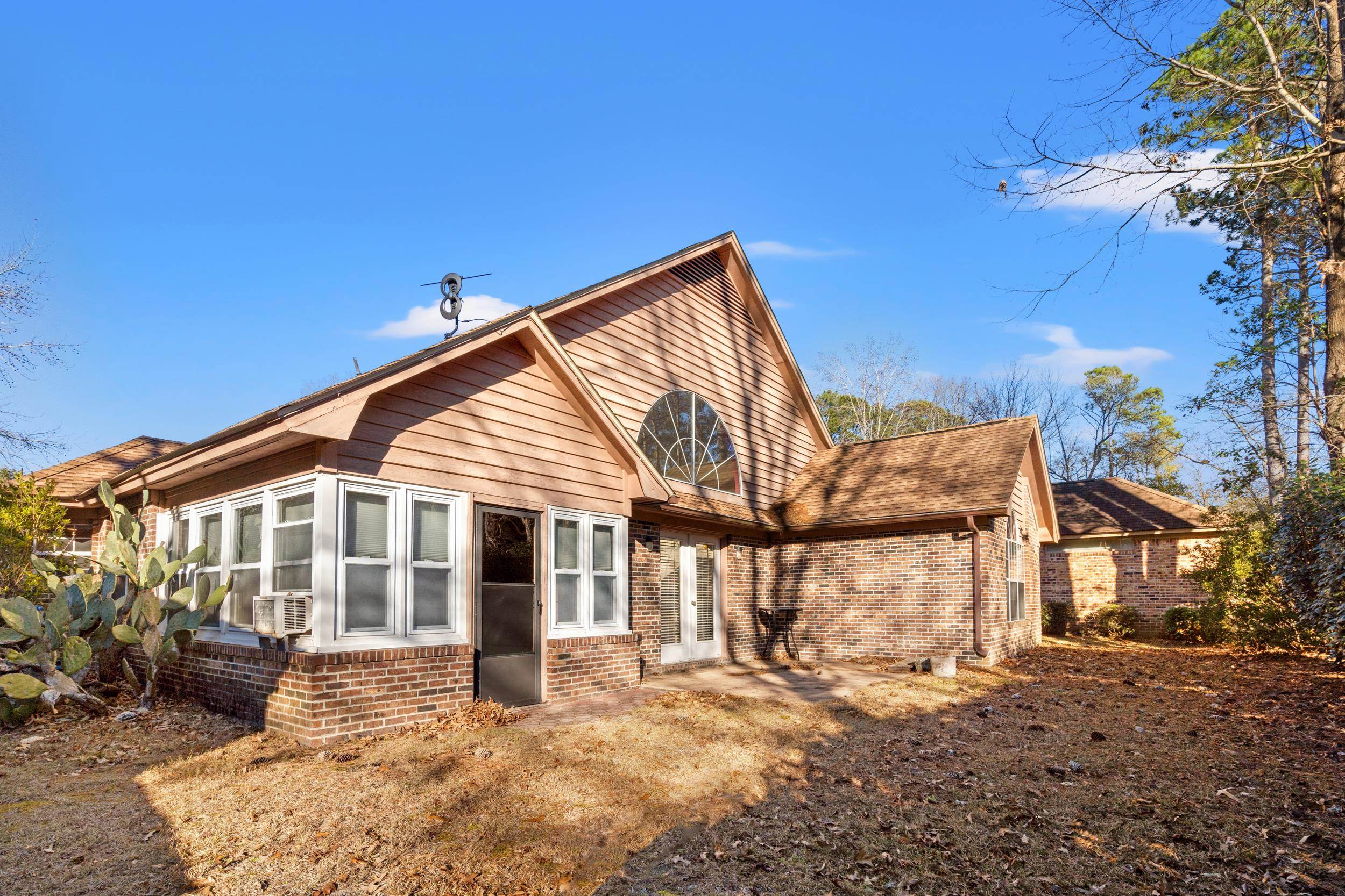 3106 Robyn Court Little River, SC 29566 - Photo 31 of 37 Rear view of property with brick siding, a sunroom, a patio, and french doors