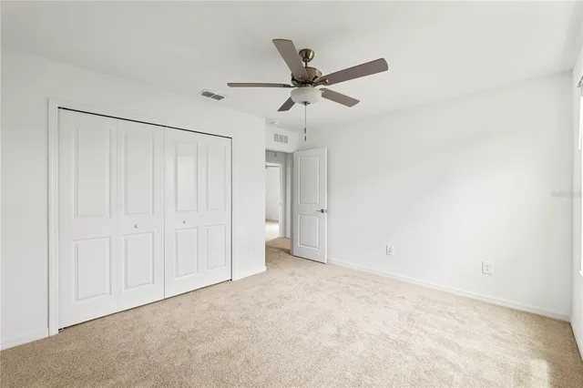 a view of a hallway with closet and bathroom