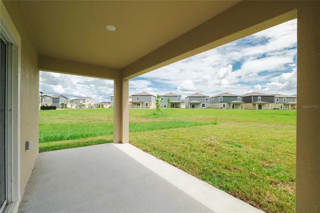 aerial view of a house with a yard