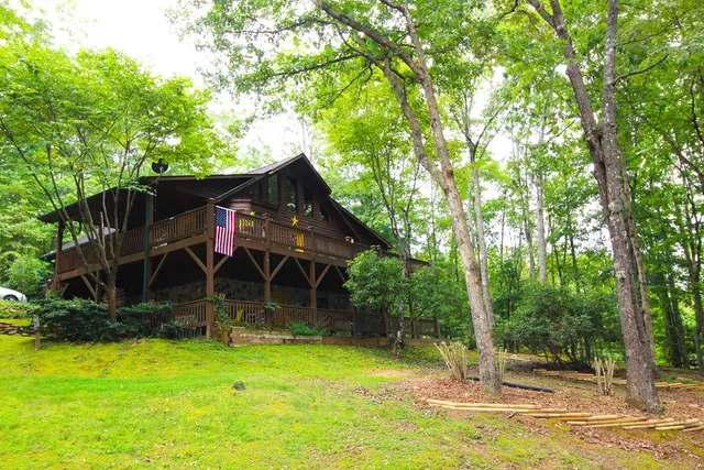 a view of a wooden house with a yard