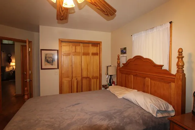 a bedroom with a bed and a cabinet