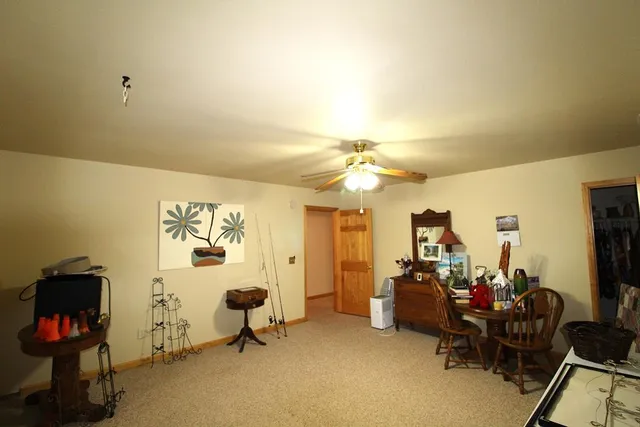 a view of a livingroom with workspace and a window
