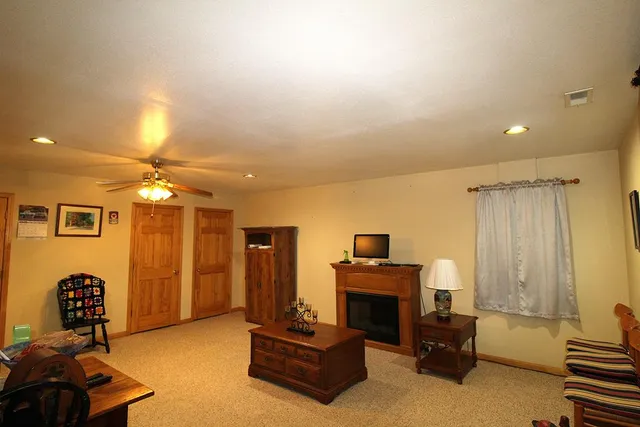 a living room with furniture chandelier and a flat screen tv