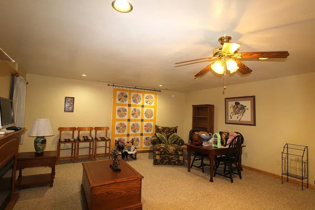 a living room with furniture and a chandelier