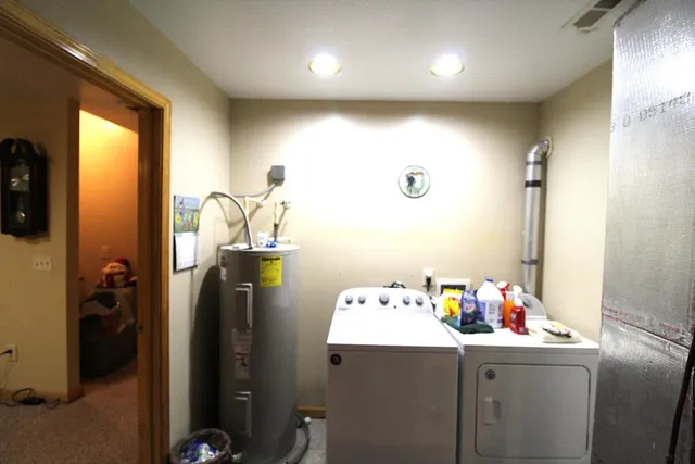 a view of backyard with table and chairs and wooden fence