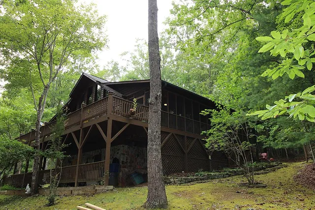 a backyard of a house with table and chairs