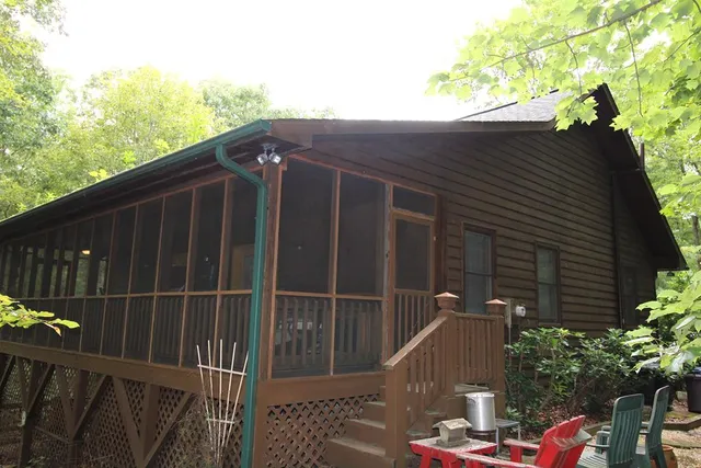 a view of a deck with chairs a barbeque grill with wooden fence