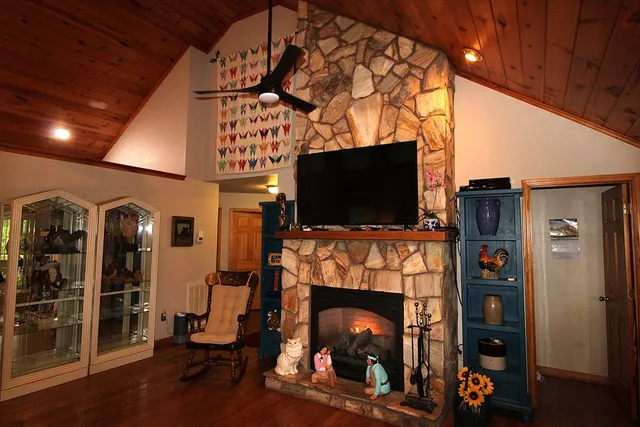 a living room with fireplace furniture and a flat screen tv