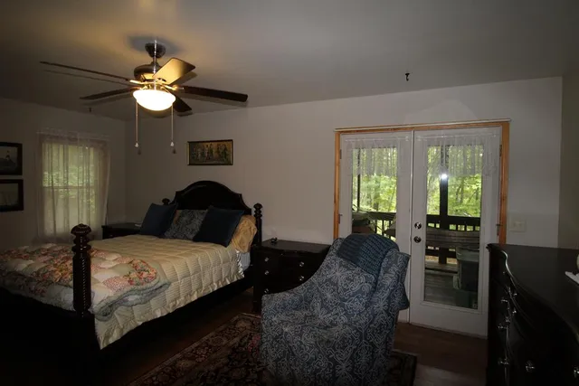 a bedroom with bed and a large window