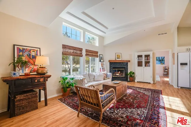 a living room with furniture a fireplace and a window