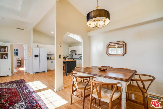 a view of a dining room with furniture and a chandelier