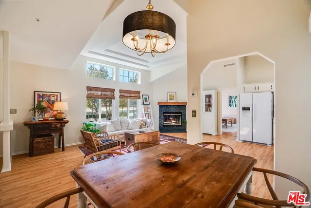 a living room with fireplace furniture and a large window
