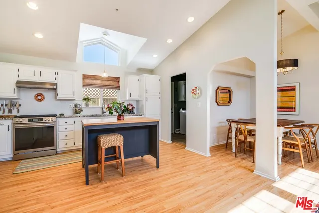 a living room with furniture a fireplace and kitchen view
