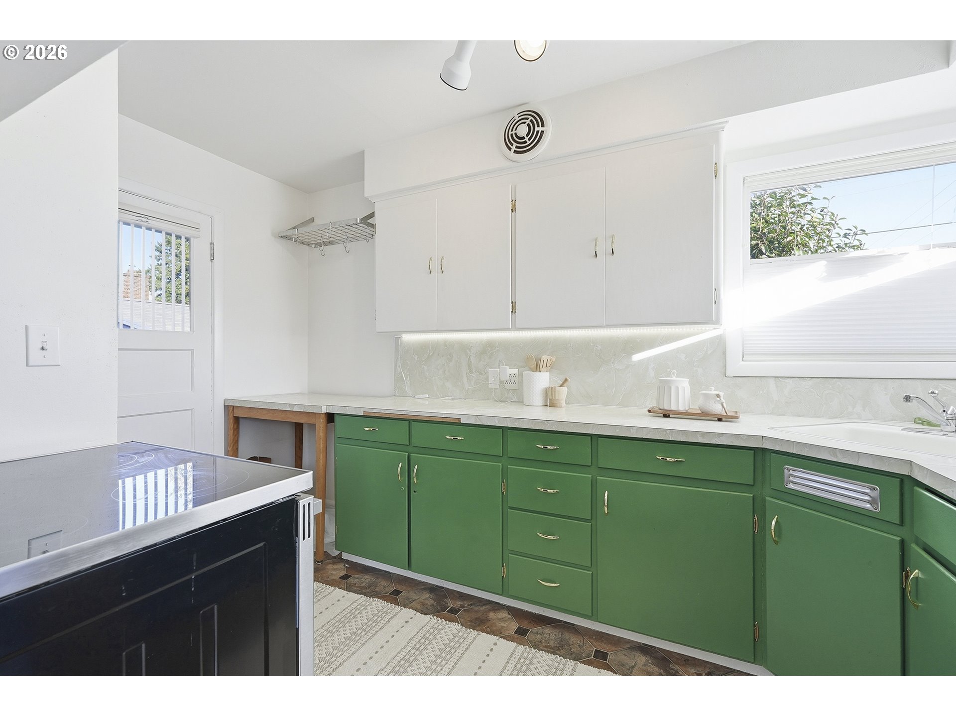 6123 Northeast Halsey Street Portland, OR 97213 - Photo 13 of 46 a kitchen with a sink cabinets and a wooden floor