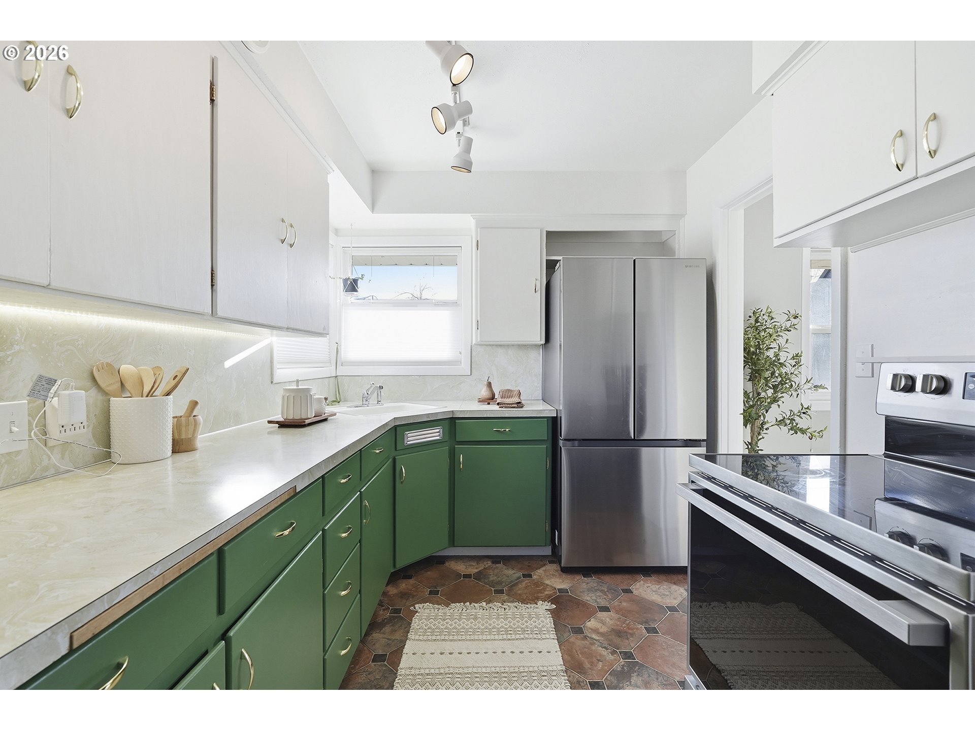 6123 Northeast Halsey Street Portland, OR 97213 - Photo 14 of 46 a kitchen with a refrigerator and a sink