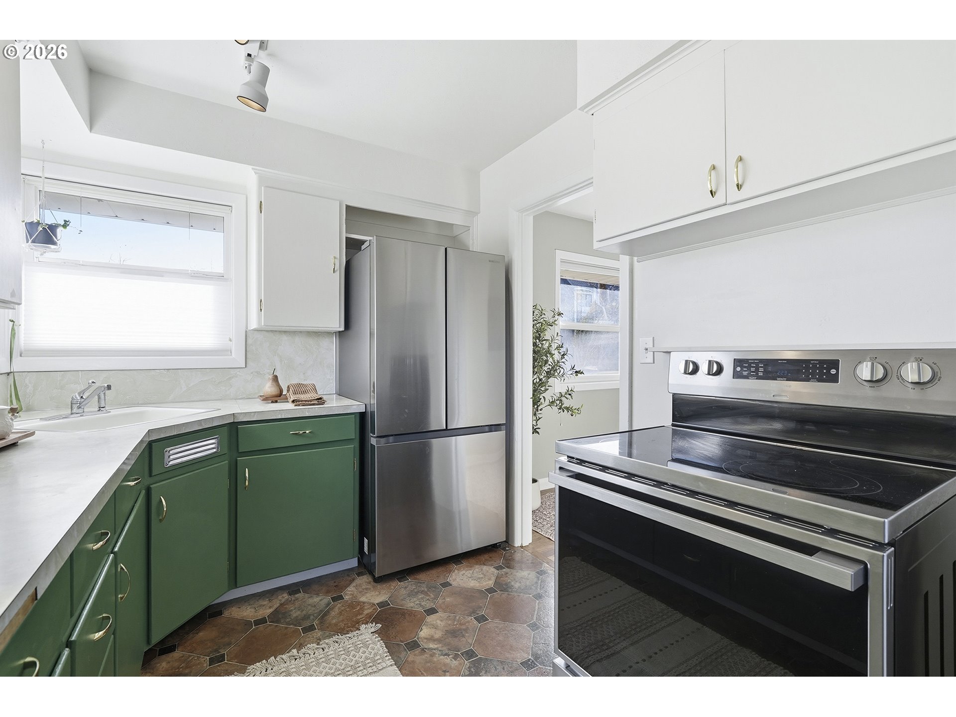 6123 Northeast Halsey Street Portland, OR 97213 - Photo 15 of 46 a kitchen with a refrigerator and a sink