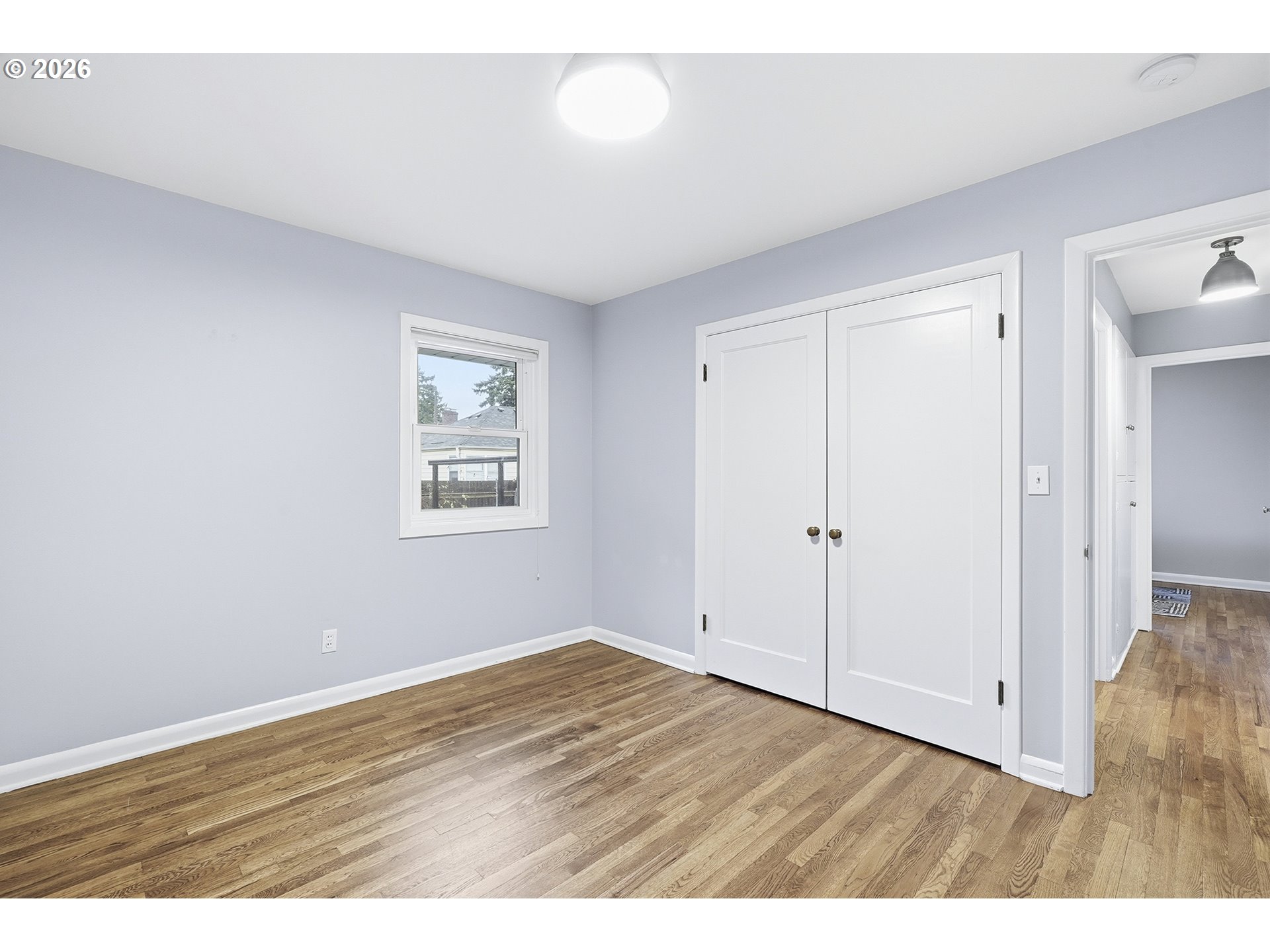 6123 Northeast Halsey Street Portland, OR 97213 - Photo 18 of 46 a view of an empty room with wooden floor