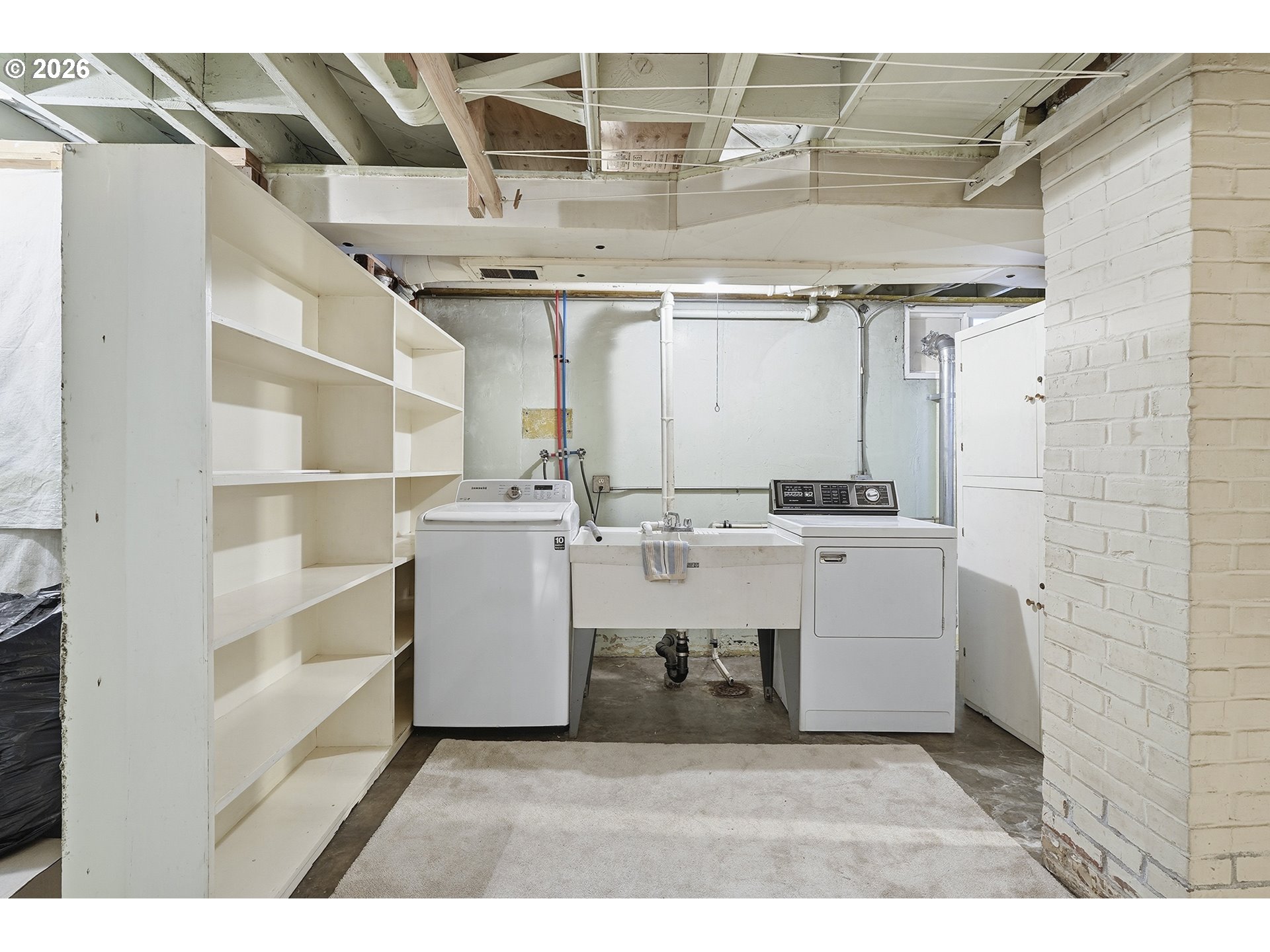 6123 Northeast Halsey Street Portland, OR 97213 - Photo 33 of 46 a room with cabinets and washer