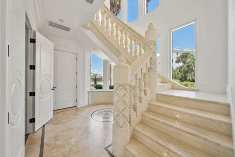 a view of a hallway with wooden floor and entryway