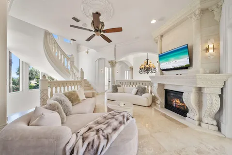 a large kitchen with a large counter top space a sink stainless steel appliances and cabinets