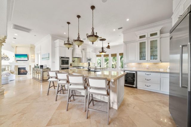 a very nice looking kitchen with a large window appliances and cabinets