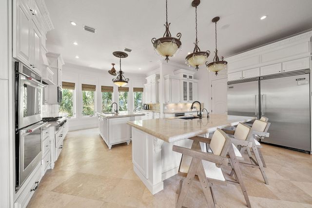 a view of a dining room with furniture a chandelier and wooden floor