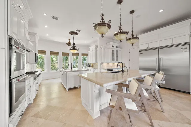a view of a dining room with furniture a chandelier and wooden floor