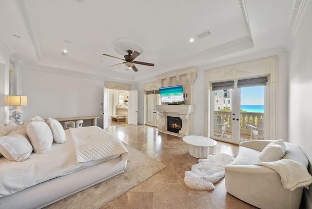 a view of a livingroom with furniture a chandelier windows and wooden floor