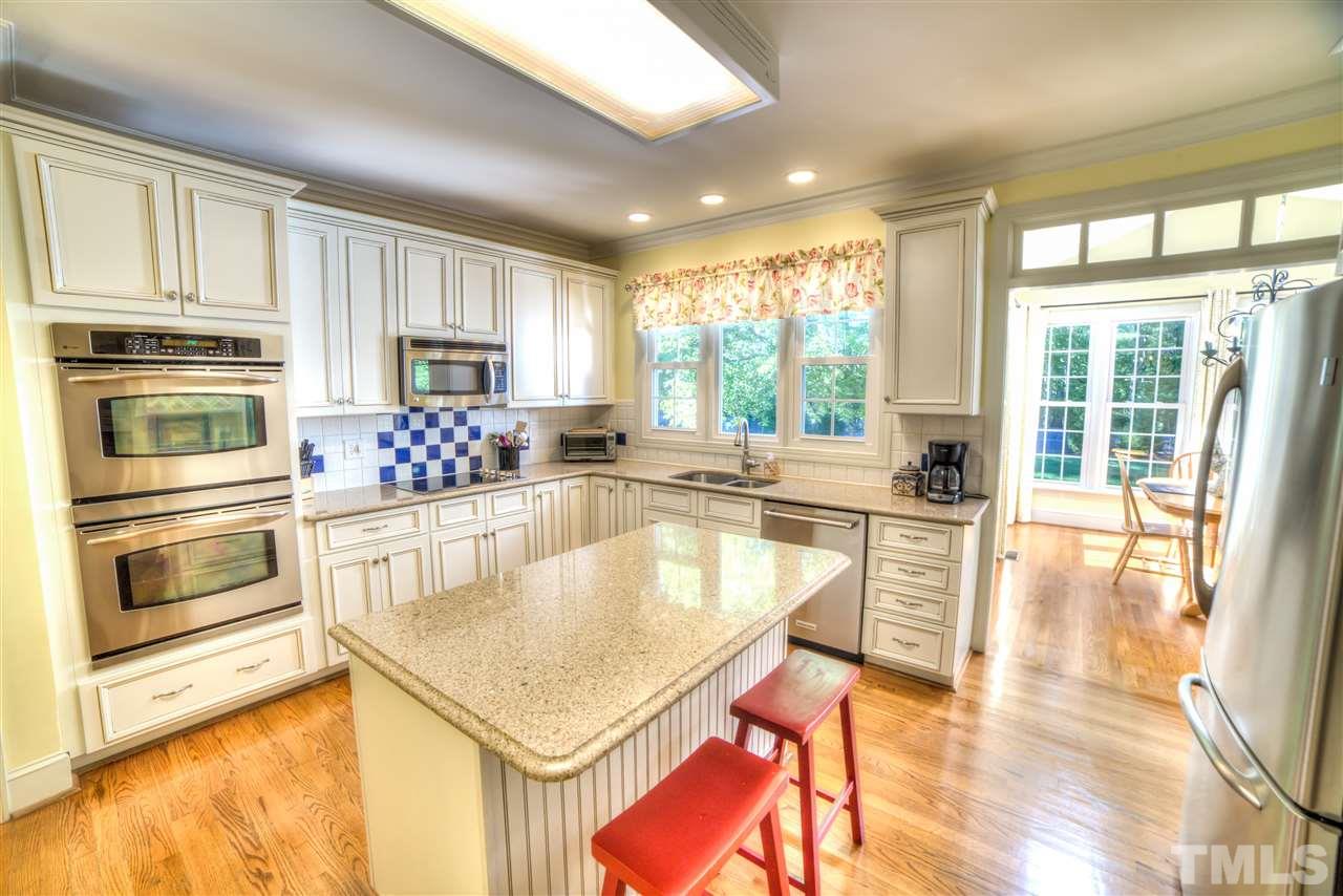 5228 Caber Road Raleigh, NC 27613 - Photo 3 of 25 a kitchen with a stove a sink and a refrigerator