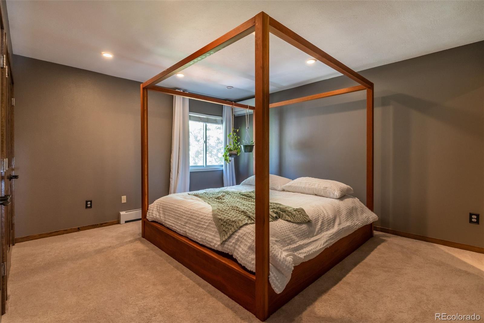 1633 4th Street, Unit C Boulder, CO 80302 - Photo 19 of 40 a bed sitting in a bedroom next to a window