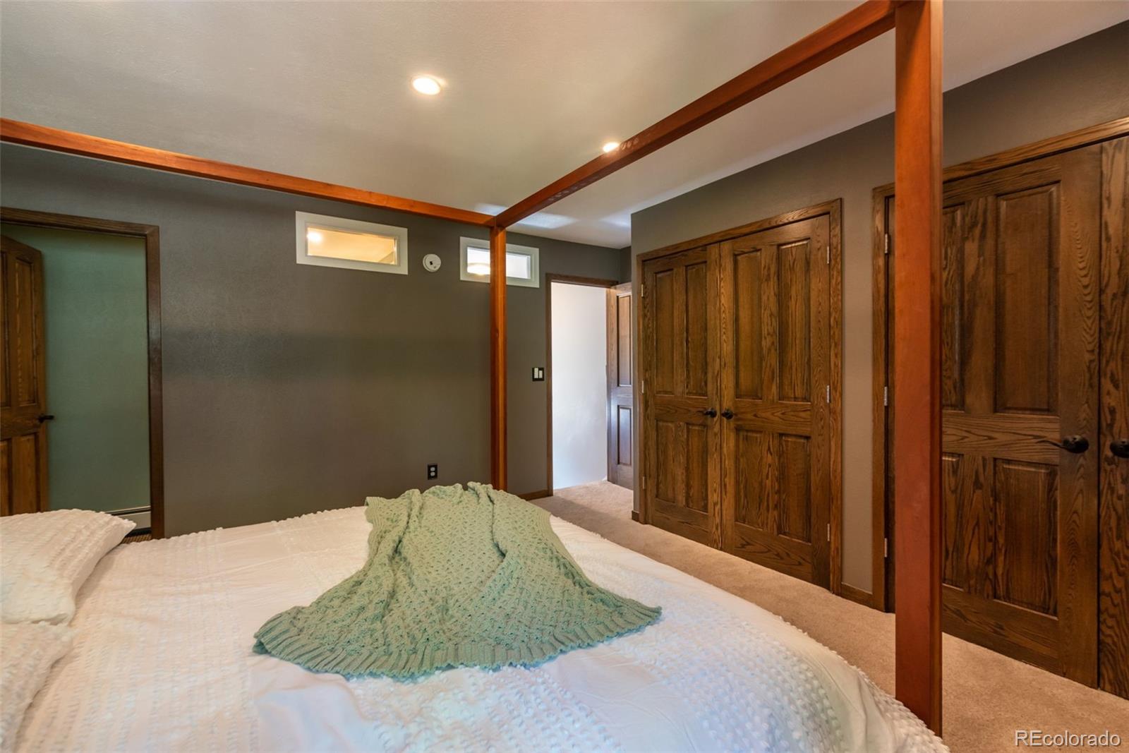 1633 4th Street, Unit C Boulder, CO 80302 - Photo 20 of 40 a bedroom with a large bed and a chandelier
