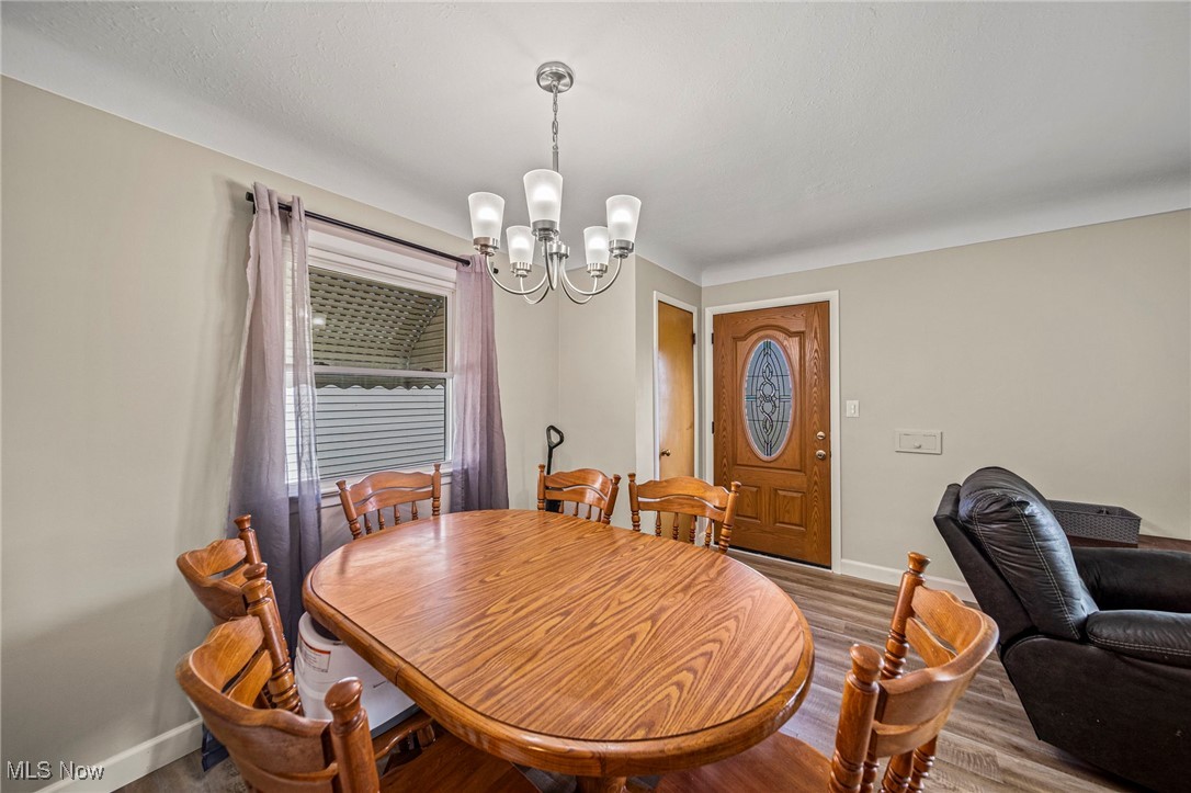 Dining space with a chandelier and wood finished floors