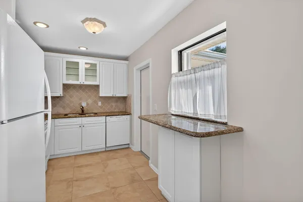 a kitchen with stainless steel appliances granite countertop a sink and a stove