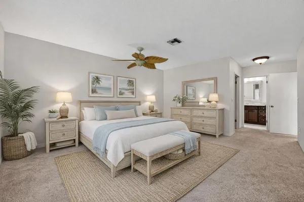 a spacious bedroom with a bed and a couch