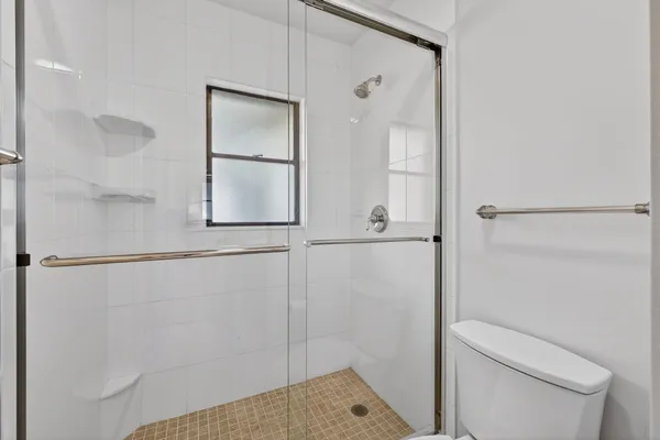 a bathroom with a shower and toilet
