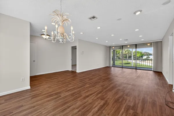 a view of a room with wooden floor and large window