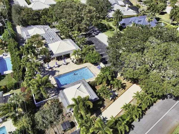 an aerial view of a house with a yard and garden