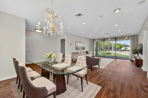 a view of a dining room with furniture wooden floor and a chandelier