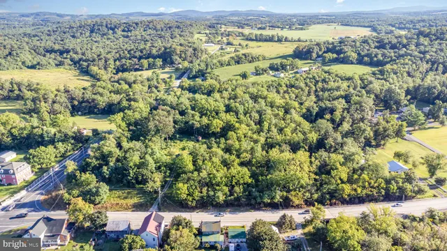 an aerial view of residential houses with outdoor space and swimming pool