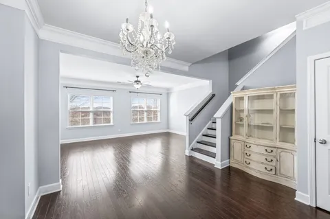 a view of an entryway with wooden floor and staircase
