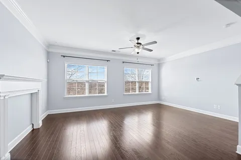 a kitchen with stainless steel appliances granite countertop a stove refrigerator dining table and chairs