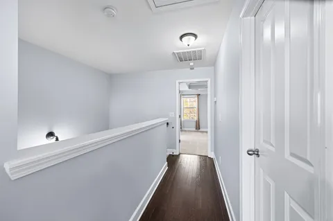 a spacious bedroom with a bed and ceiling fan